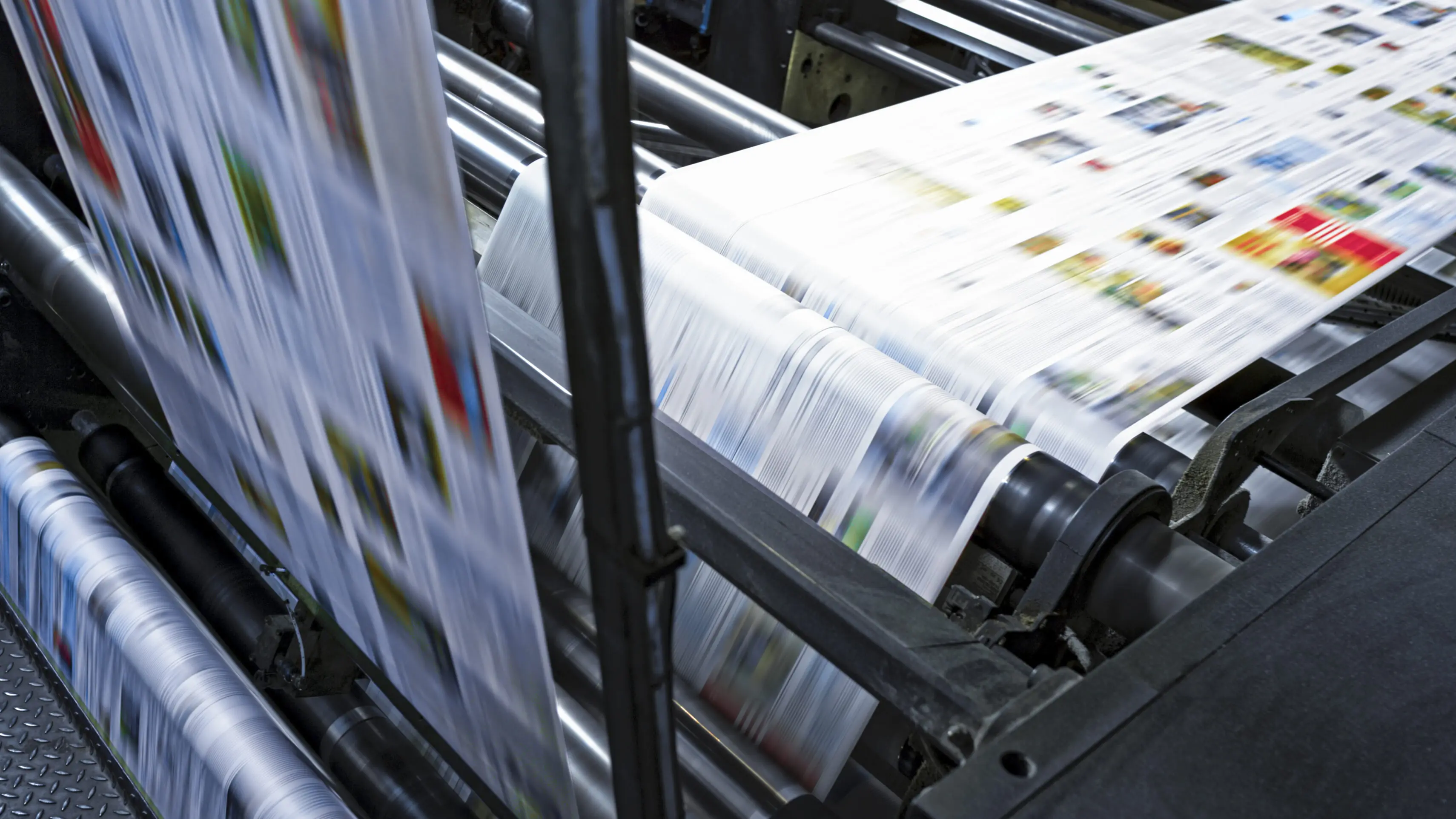 Printing press producing colorful printed sheets rapidly.