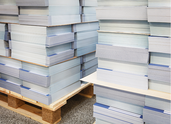 Stacks of paper on wooden pallets