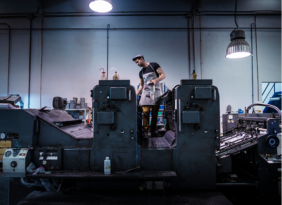 Printing press operator in workshop