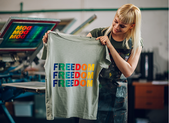 Woman holding printed "Freedom" t-shirt